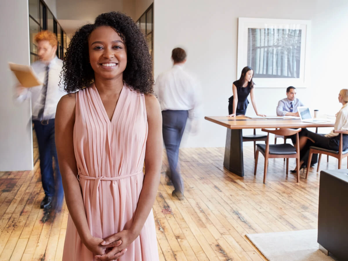 Invessed woman in office in pink dress