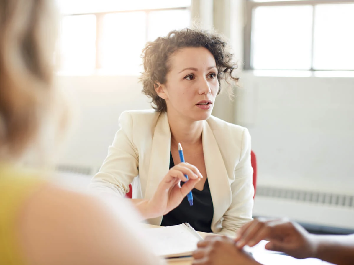 Woman at desk with pen